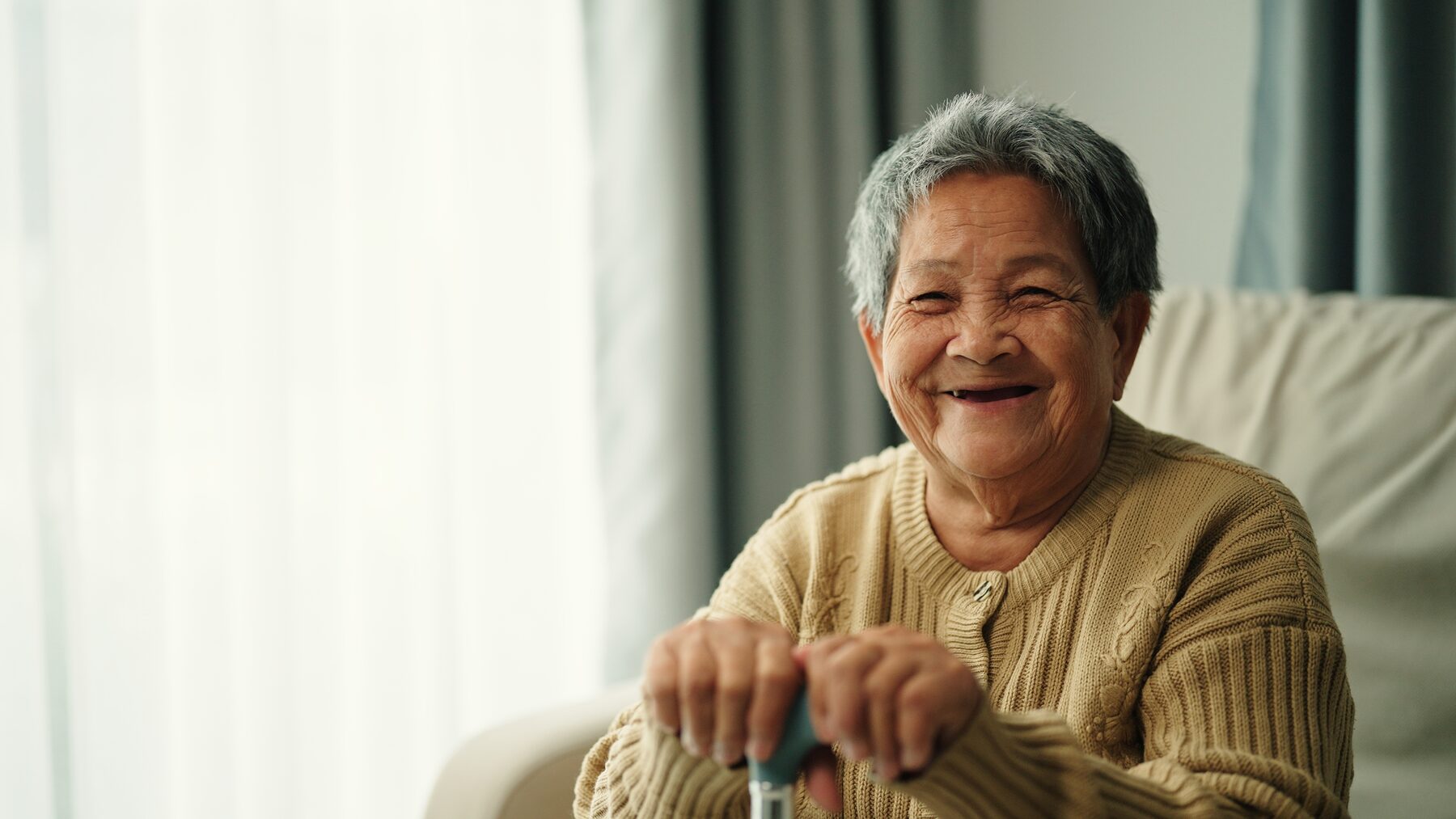 Smiling resident near a window, soft light